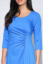 Rochia Celine din jerseu elastic albastru, croi asimetric și detaliu drapat